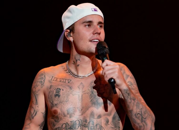 Justin Bieber with a T-shirt on his head walks the streets of New York