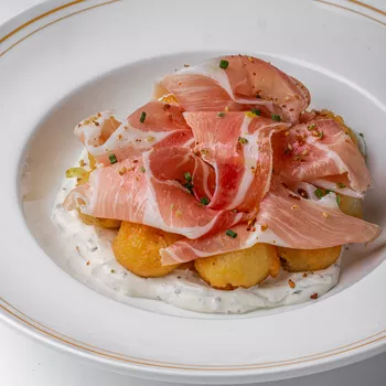 Картофельные пончики с пармской ветчиной и трюфельной сметаной