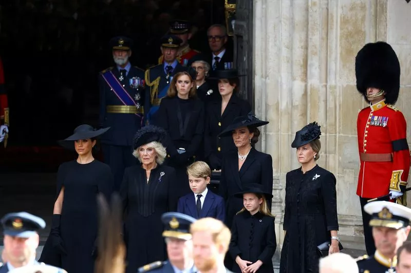 У входа в Вестминстерское аббатство гроб королевы ожидали дети и внуки королевы, а также герцогиня Сассекская Меган, королева-консорт Камилла, принцесса Уэльская Кейт, ее дети Джордж и Шарлотта, графиня Уэссекская Софи, принцессы Беатрис и Евгения, принцы Майкл и Эдвард Кентские